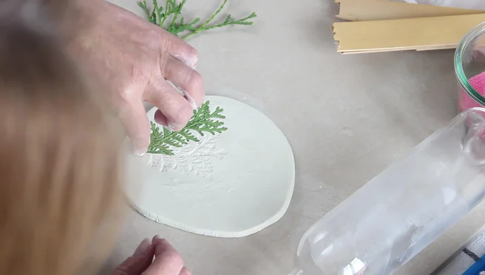 Gently lift the branches to reveal the imprint.