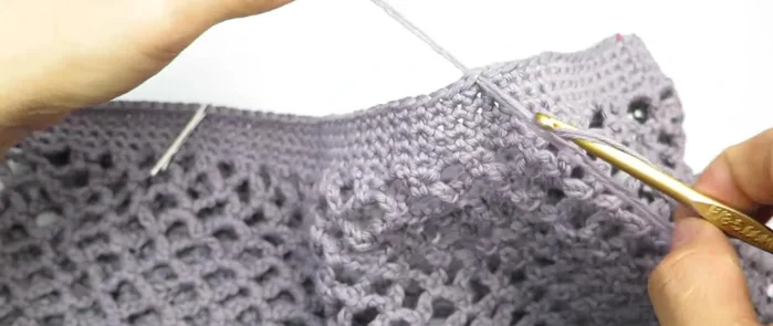 Create handles: Chain 80, attach to the marked stitches on the bag, single crochet along the chain in the back loop only, join and fasten off.