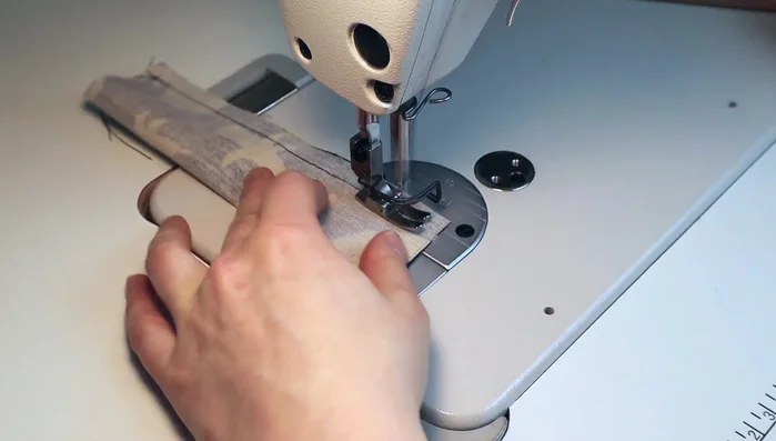 Make the tabs: Fold fabric in half and sew a 1-centimeter seam allowance. Use a chopstick to turn right side out.