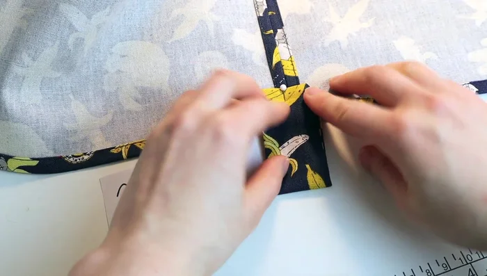 Measure and pin tabs (5 centimeters sticking out) before sewing them onto the curtain.