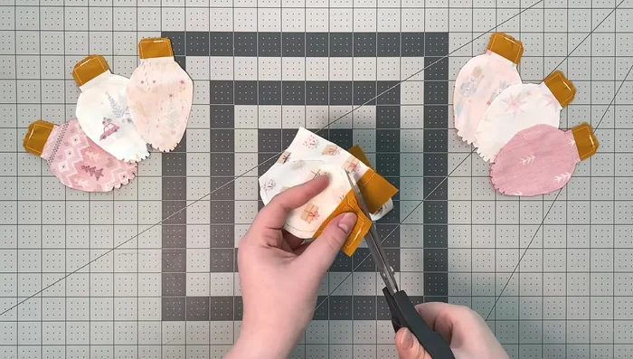 Cut 1/4 inch around the sewn line, trim corners at an angle, and make notches at the bulb's end for easy turning.