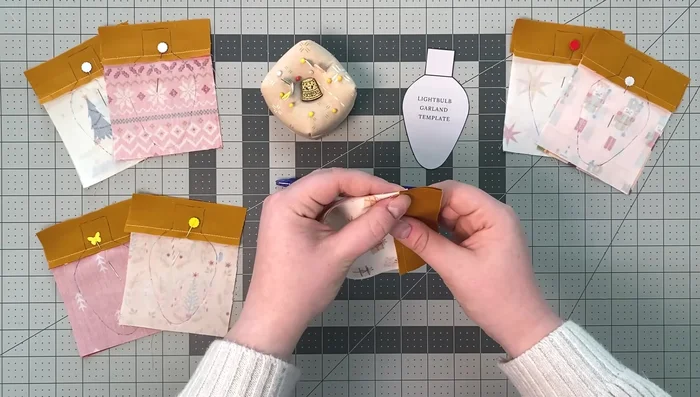 Cut 1/4 inch around the sewn line, trim corners at an angle, and make notches at the bulb's end for easy turning.