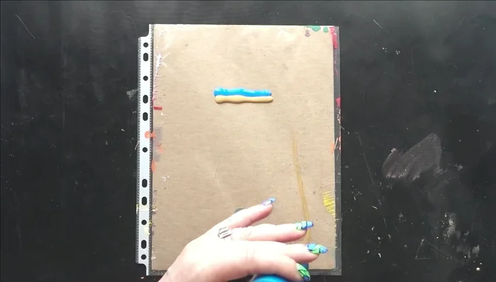 Swipe through the stripes with black paint using a cake knife to create cells.