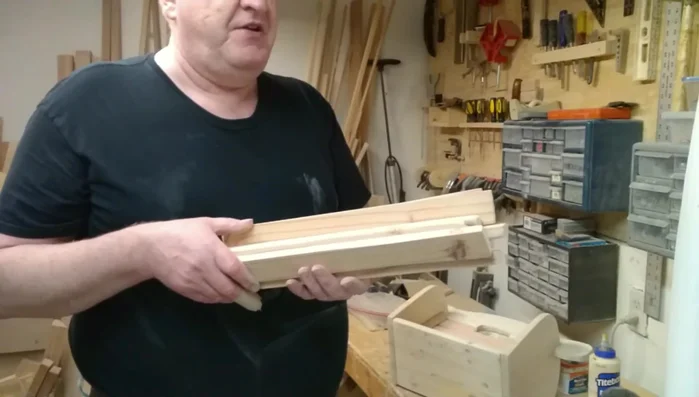 Attach the front rails: Glue and clamp additional strips to the front of the divider, using spacers for even spacing. Allow to dry.