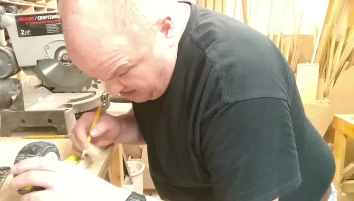 Attach the feet: Glue and clamp two 7-inch long, 1/2x1/2 inch strips of wood to the bottom of the rack as feet. Ensure they are square and evenly spaced.