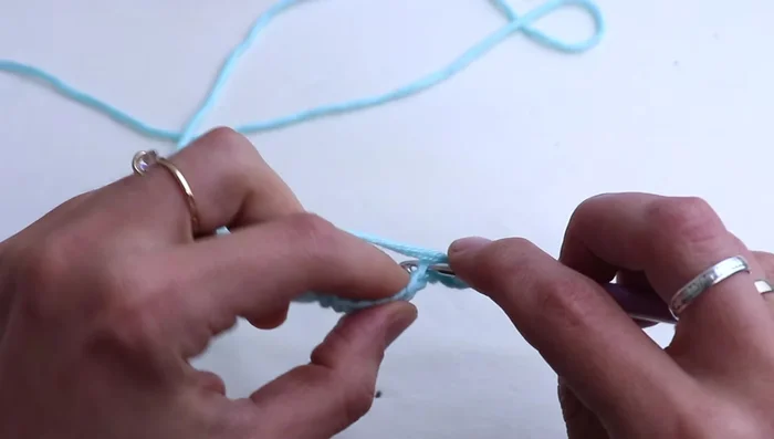 Work 1 half double crochet (hdc) in the 2nd chain from the hook, then 1 hdc in each of the next 2 chains. Work 3 hdc in the central stitch, then 1 hdc in each of the next 3 chains. Place a stitch marker in the central 3 hdc.