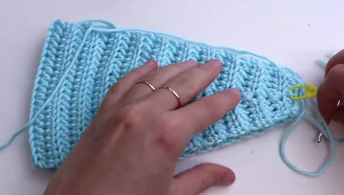 Finishing: Crochet several rows without increases or decreases to create a clean edge. Choose your preferred finishing method (seaming, buttonhole and button, or magnetic snap).