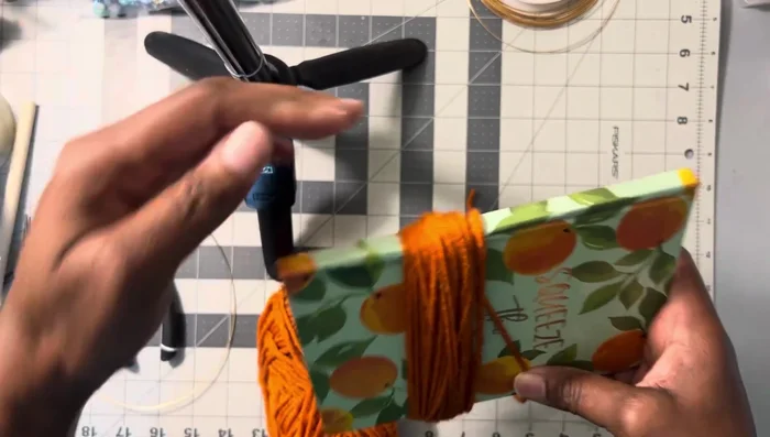 Cut the wrapped yarn.