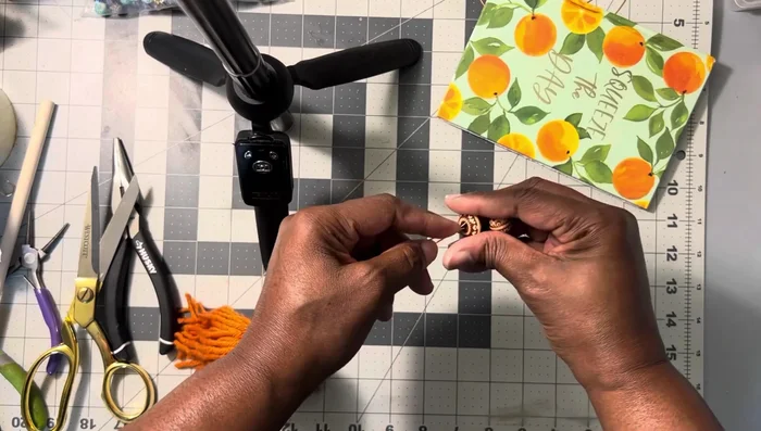 Push the beads down, holding them in place. Wrap another wire around the long wire end to secure the beads.