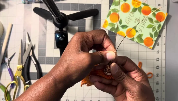 Push the beads down, holding them in place. Wrap another wire around the long wire end to secure the beads.