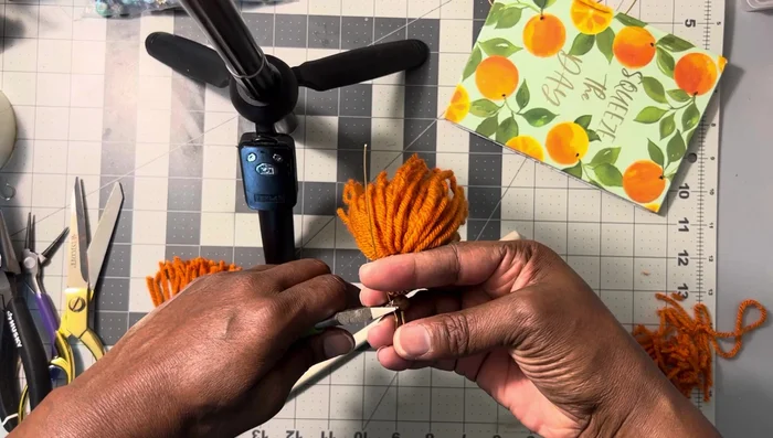 Cut off the excess wire after creating the loop. Sand the end of the wire to make it smooth against the ear.