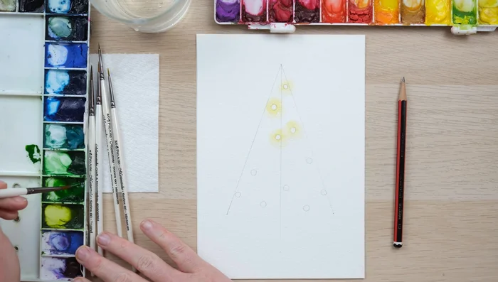 Continue painting the tree, remembering to use less paint near the lights.
