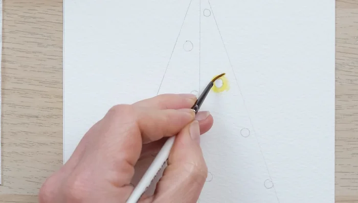 Paint the top half of the tree using this technique, ensuring the lights remain wet for a seamless blend with the tree.