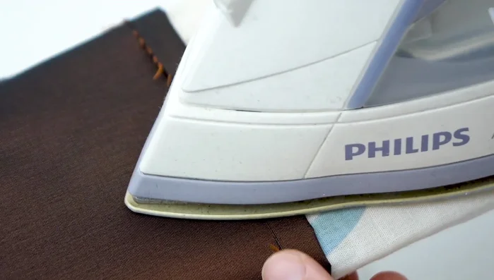 Hem the top: Fold the top edge over twice (1cm each time), press, and sew a close seam.