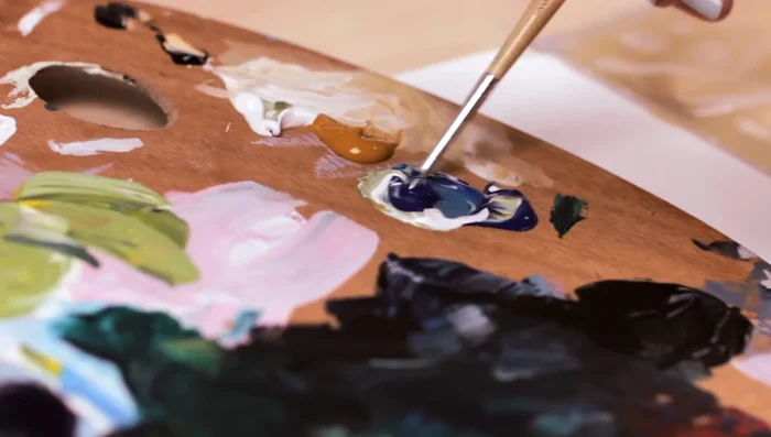 Mix different shades of blue. You can hold the mixed paint against a printed image to check the accuracy of the shade.