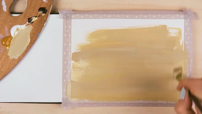 Apply a thin layer of the grayish-brown base color all over the paper or canvas.