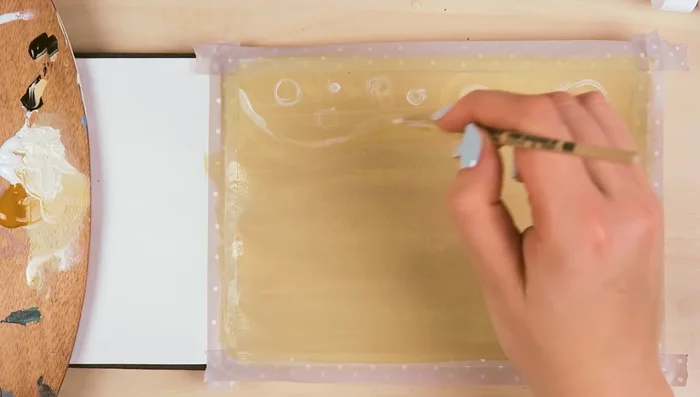 While the paint dries, sketch the painting using watercolor paint and a thin brush. This helps map out the painting and prevents feeling lost while painting.