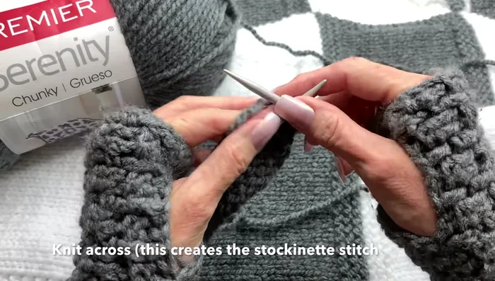 Continue alternating knit and purl rows (knit three, purl nineteen, knit three) for 13 rows to create a stockinette stitch panel with garter stitch borders.