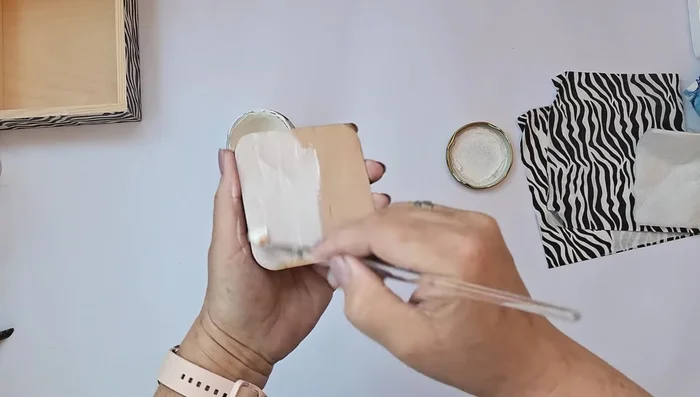 Create a small overlay with the same zebra pattern for the inside of the lid. Prime, decoupage, and varnish.