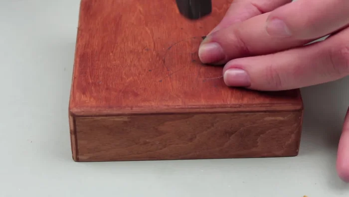 Hammer nails into the marked points, starting with the center.