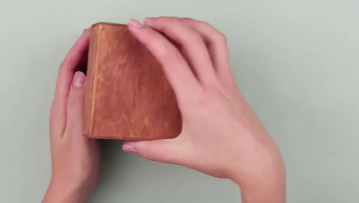 Draw the dandelion pattern on the box lid. Mark the center, draw a smaller inner circle, and mark points following the pattern. Use a ruler for easier marking.