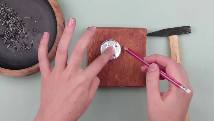 Draw the dandelion pattern on the box lid. Mark the center, draw a smaller inner circle, and mark points following the pattern. Use a ruler for easier marking.