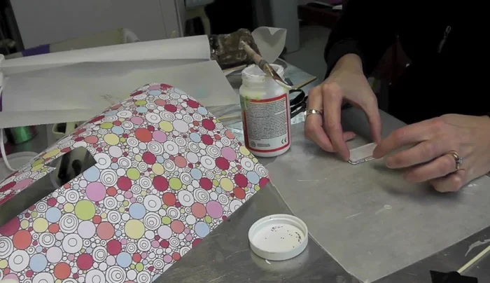 Place the glass, Mod Podge side down, onto the cut paper, pressing gently to adhere.