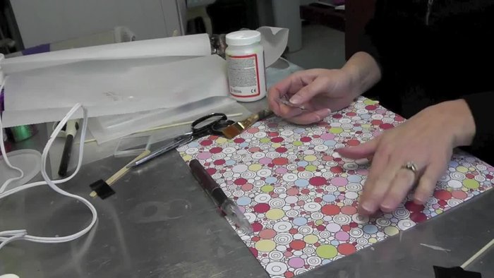 Choose your scrapbook paper and glass circle. Position the glass on the paper to find a pleasing design.