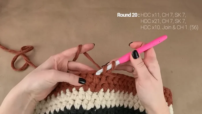 Round 21: Work hdc in first 11 stitches, hdc 7 across first handle, hdc in next stitch, hdc in next 20 stitches, hdc 7 across second handle, hdc in remaining stitches.