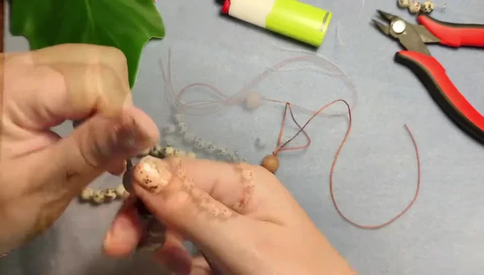 Tie a double overhand knot on each tassel, pull tight, and burn the ends.