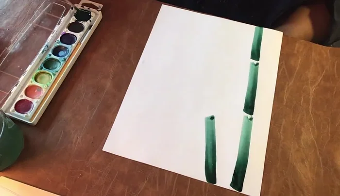 Repeat step 2 to create multiple bamboo stalks, arranging them across the paper, overlapping as desired. Note the natural variations in light and dark values.