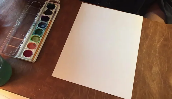 Prepare your watercolor set, brush, and water. Wet your black paint until it's juicy and loose.