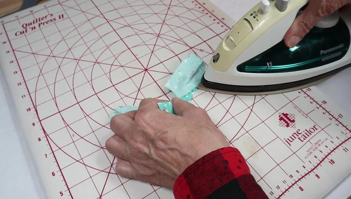 Fold and press the armholes.