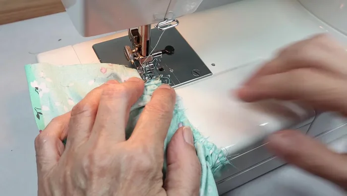 Sew the skirt to the bodice, hiding the gathering stitches.