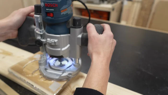 Using the router, carefully carve the lantern face design, moving clockwise.
