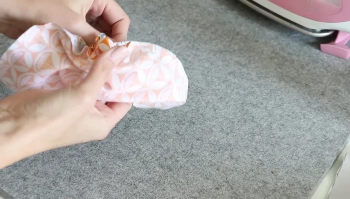 Turn right side out and press: Turn the sewn pieces right side out through the opening. Use your fingers to roll the seam allowances to the outside, creating a flat edge. Press with an iron to smooth the seams and remove wrinkles.