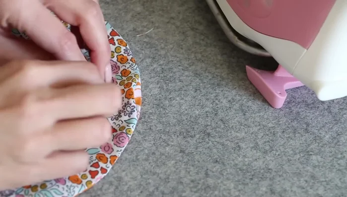 Close the opening: Fold the raw edges of the opening inward, aligning them carefully. Press and sew around the edge of the circle to close the opening using a similar seam allowance as before.