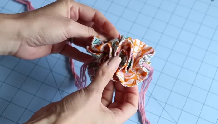 Tie and trim: Pull the cord or ribbon to gather the pouch, tie securely and trim the ends of your cord or ribbon.