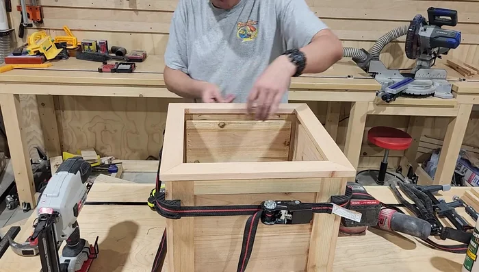 Attach the top cap to the planter using wood glue and brad nails, ensuring even overhang.