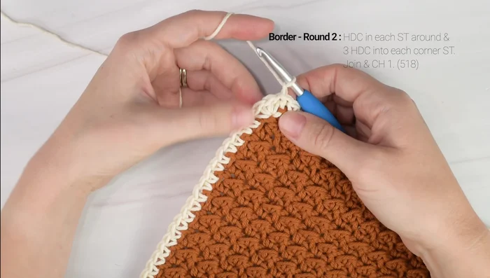 Border (Round 2): Half double crochet around. Work 3 half double crochets in each corner.