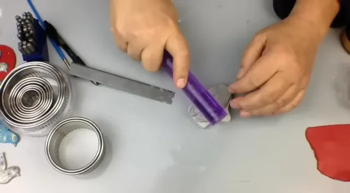 Gently demold the clay piece by pressing the mold down on a work surface and pulling back.