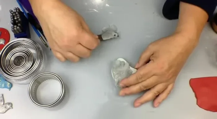 Gently demold the clay piece by pressing the mold down on a work surface and pulling back.