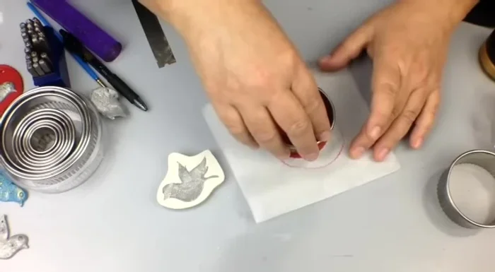 Gently demold the clay piece by pressing the mold down on a work surface and pulling back.