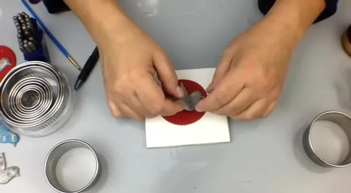 Apply gilding polish using a finger or small brush, highlighting the details of the dove and base. Add metal letter stamps for personalization.