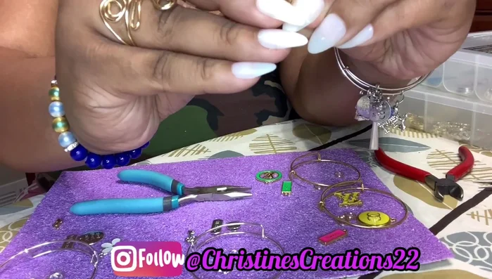 Attach the charm to the jump ring or split ring using the techniques shown in the video (around 273.18).