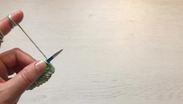 Place stitch markers: one after the garter stitch border, one after each 14-stitch repeat (lace section), and one before and after the 2-purl-stitch section between lace repeats.