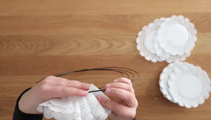 Hot glue the tail end of the doily over to secure it to the wreath.