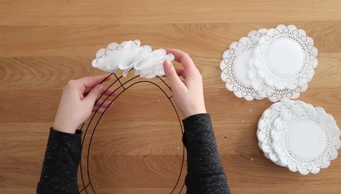 Hot glue the tail end of the doily over to secure it to the wreath.