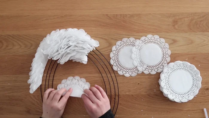 Hot glue the tail end of the doily over to secure it to the wreath.