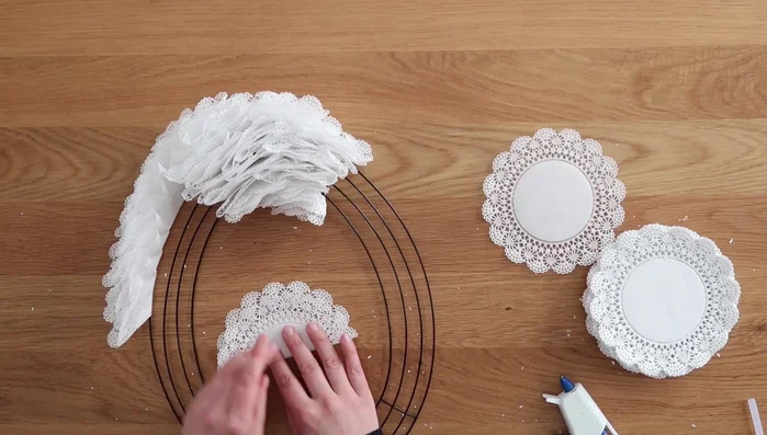 Repeat steps 1-6 until the entire wreath is covered with doilies.